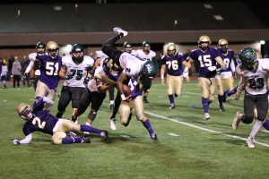 Eric Coley goes airborne after gaining a few yards vs CBA. (Photo by Wendy Cobrda)